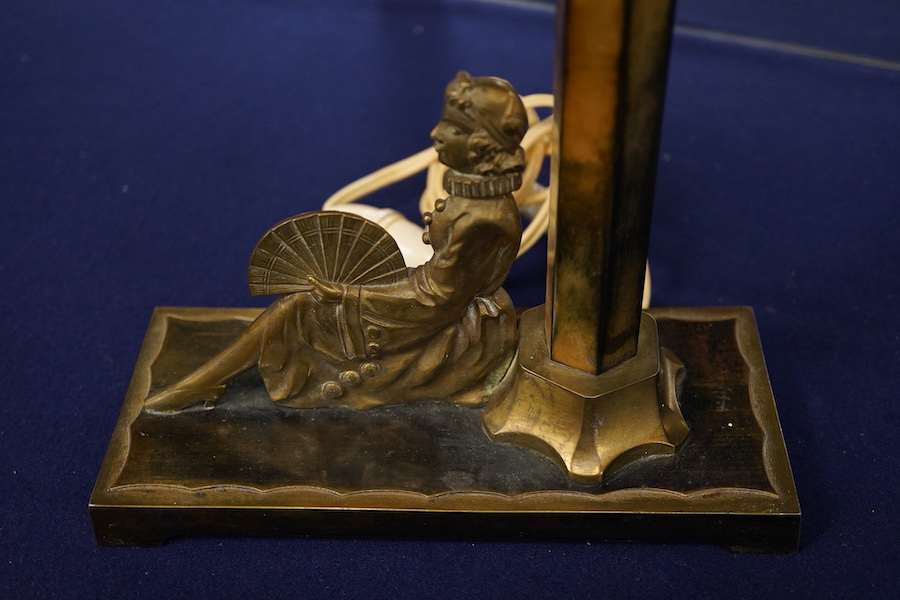 An Art Deco bronze table lamp, modelled with a seated woman holding a fan, 28cm high including shade